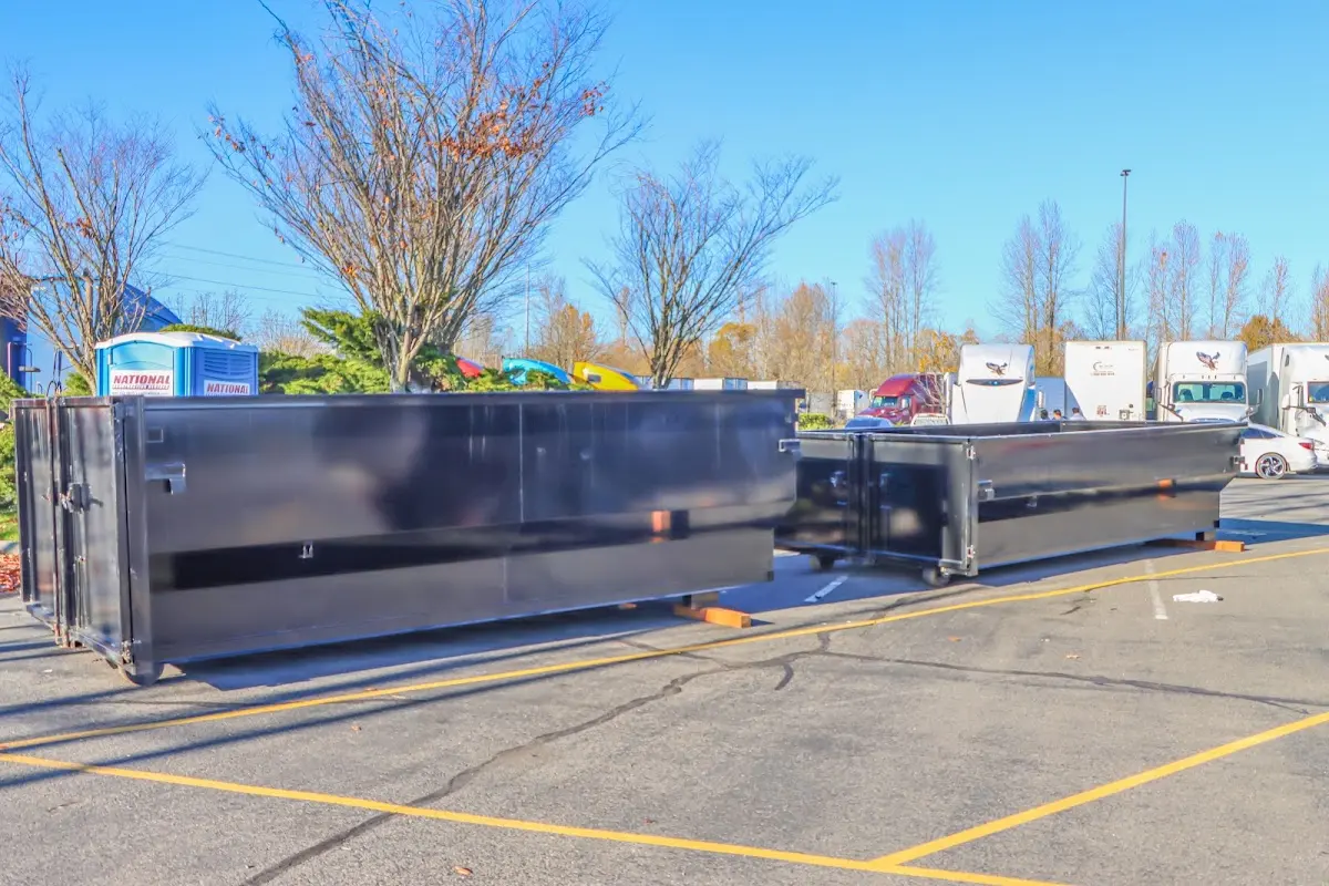 Professional dumpster rental service with roll-off container on residential driveway in Orosi